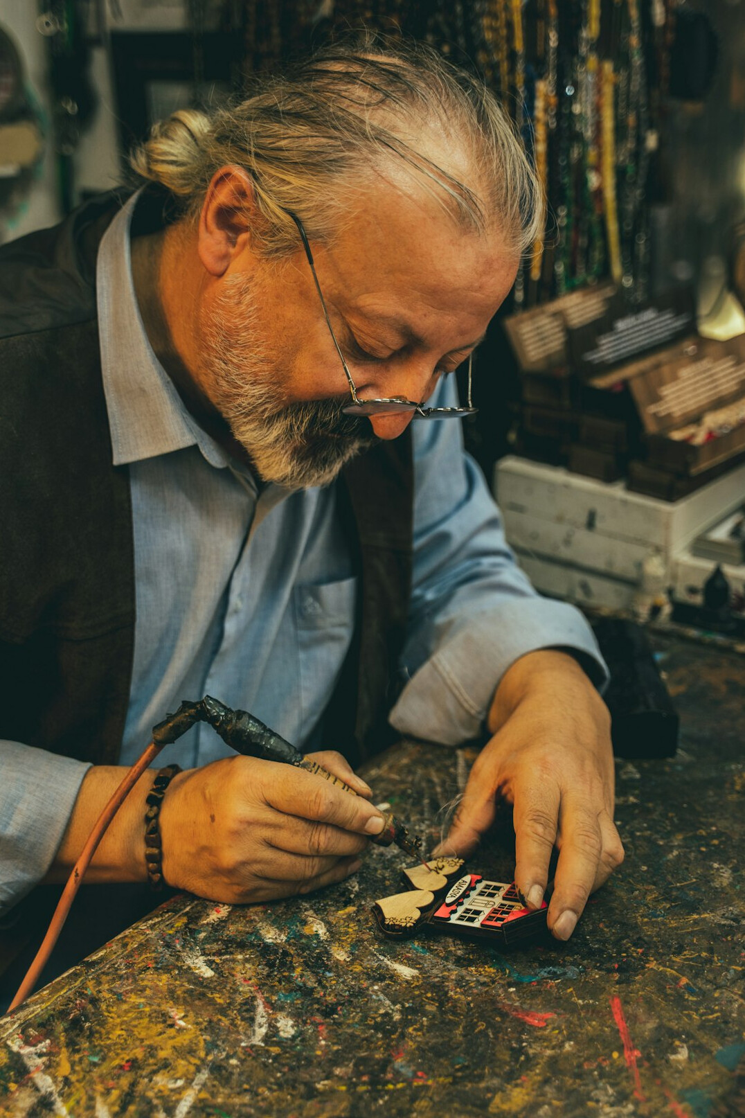 Elderly Danish craftsman working with wood tools in his workshop