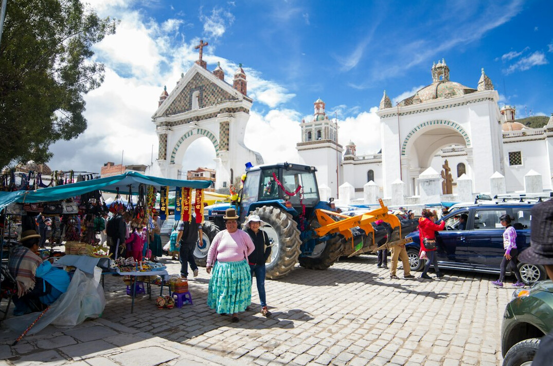 Busy local market day with vendors and customers in a Danish town square