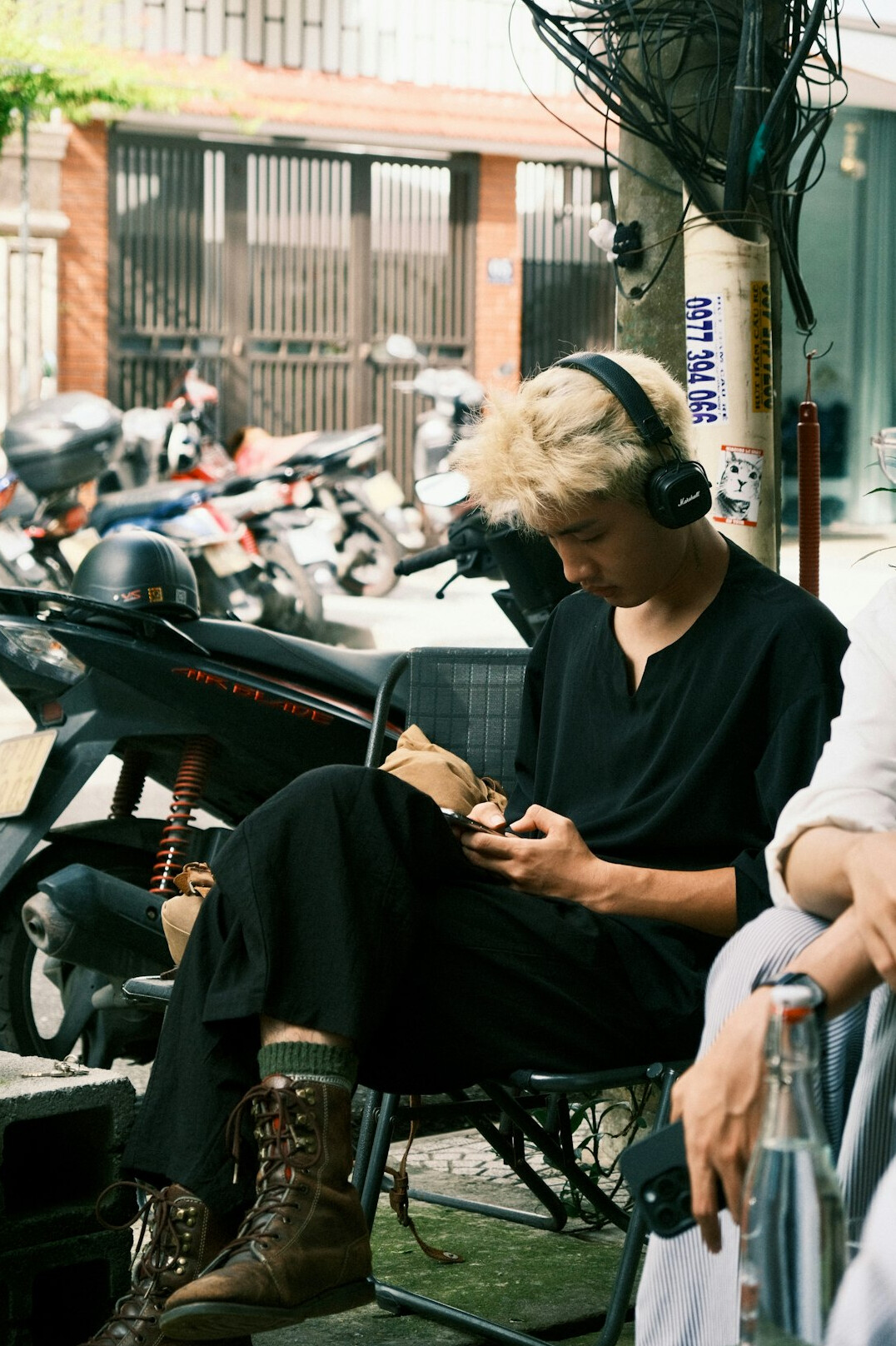 Journalist interviewing an elderly local resident outdoors with a notebook and recorder