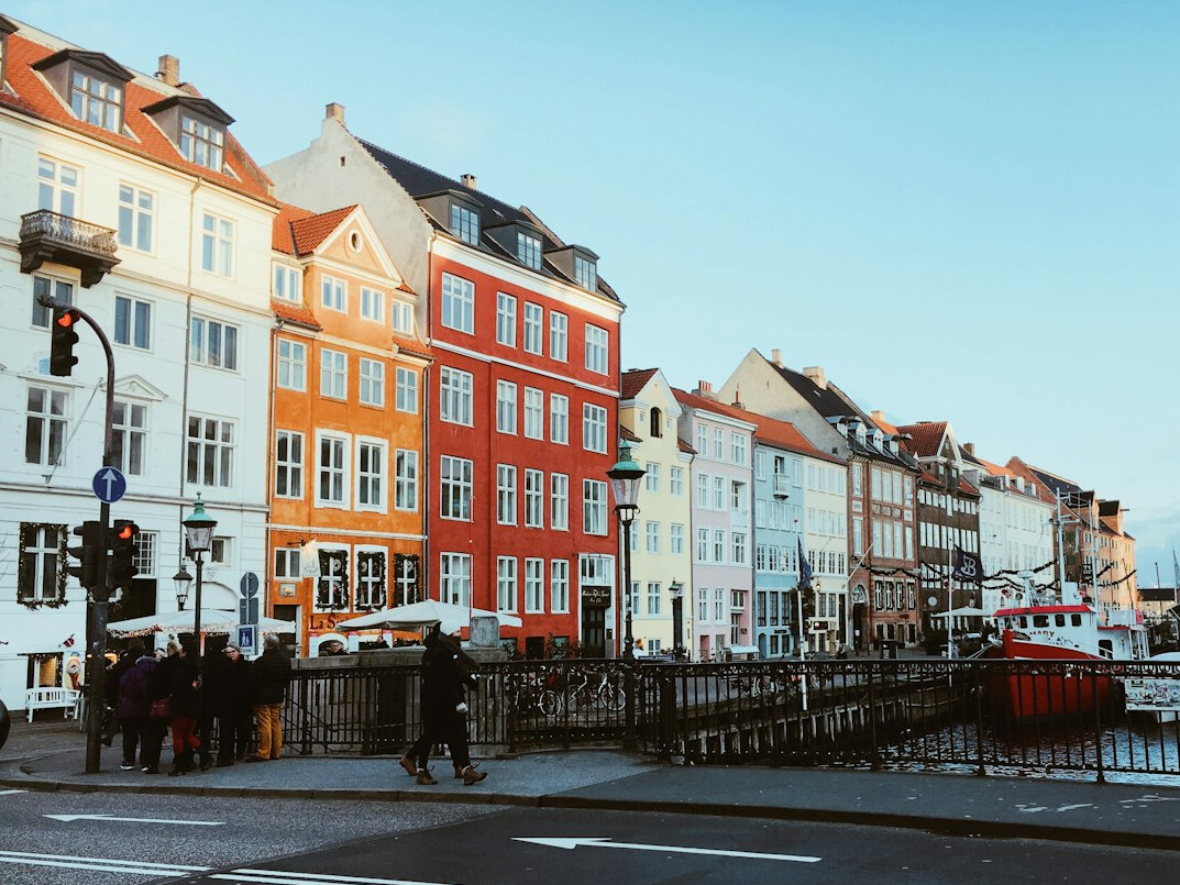 Documentary photographer photographing a street scene in a small Danish town