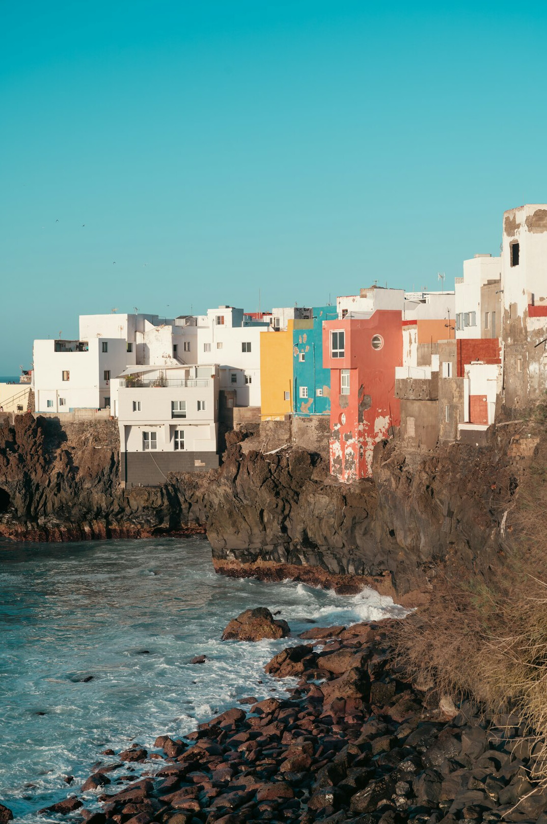 Wide view of a small Danish coastal town with colorful houses at dusk