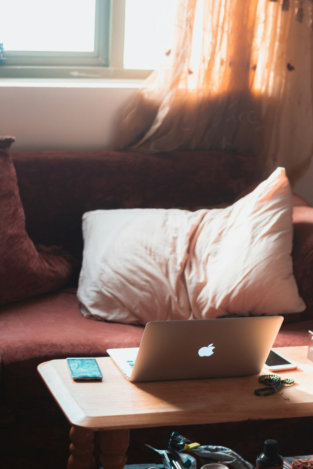 Bright editorial office desk with a laptop, notebook and coffee cup